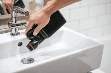 Using drain cleaner to unblock household plumbing and maintain pipes