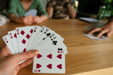 Family playing games with playing cards at home in South Africa