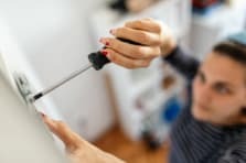 Woman using a handheld screwdriver from NSJ Wholesale for DIY projects in South Africa